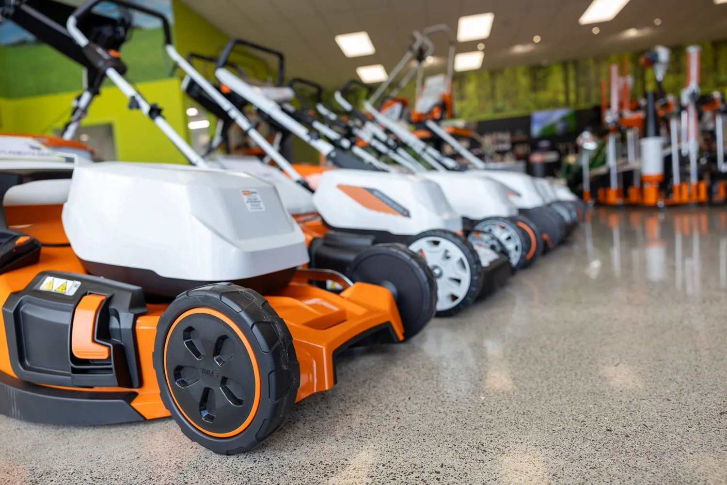 A row of lawnmowers on display in the STIHL SHOP Mt Maunganui showroom