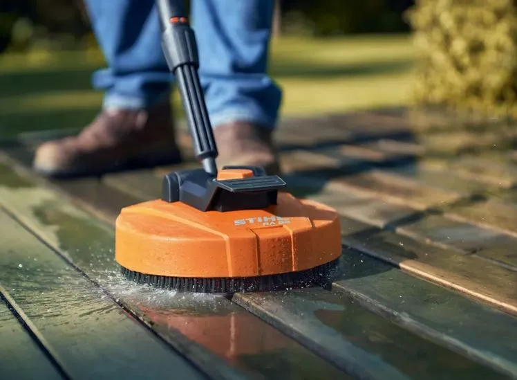 STIHL surface-cleaning attachment washing a timber deck