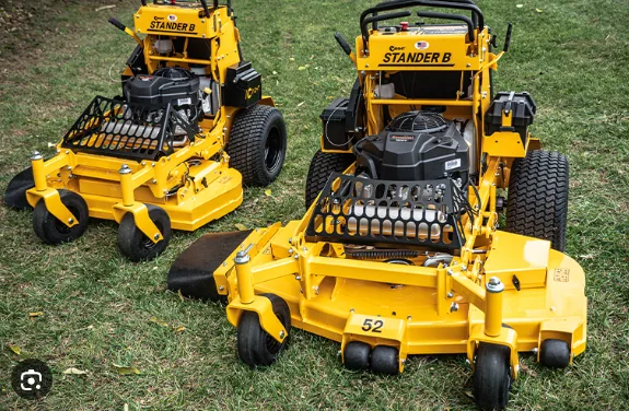Two Wright Stander B stand-on mowers on grass