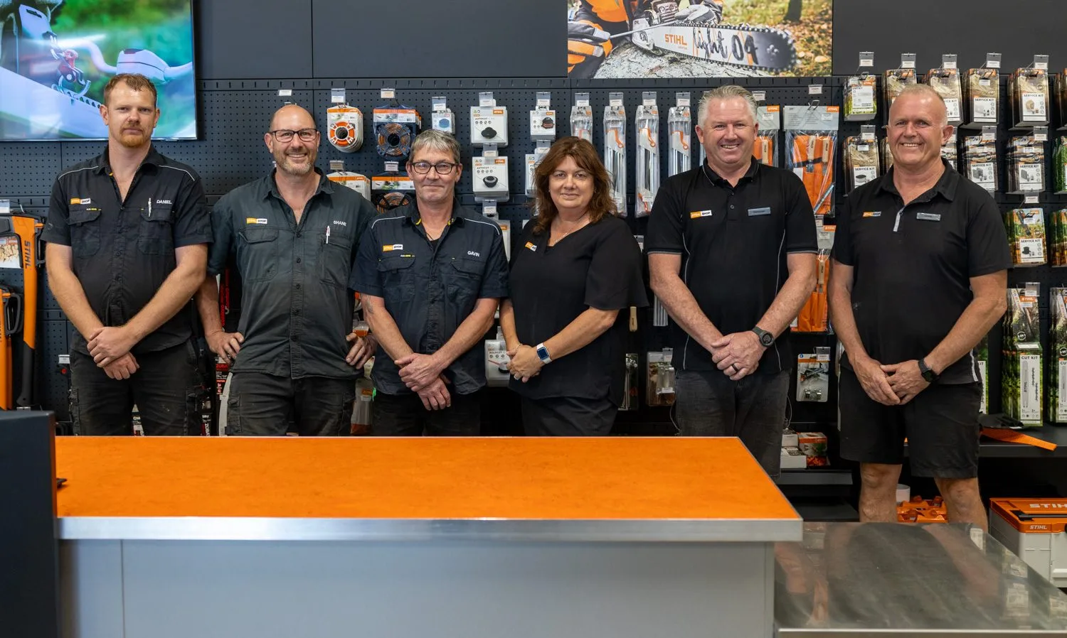 The STIHL SHOP Mt Maunganui team standing behind the counter in the showroom