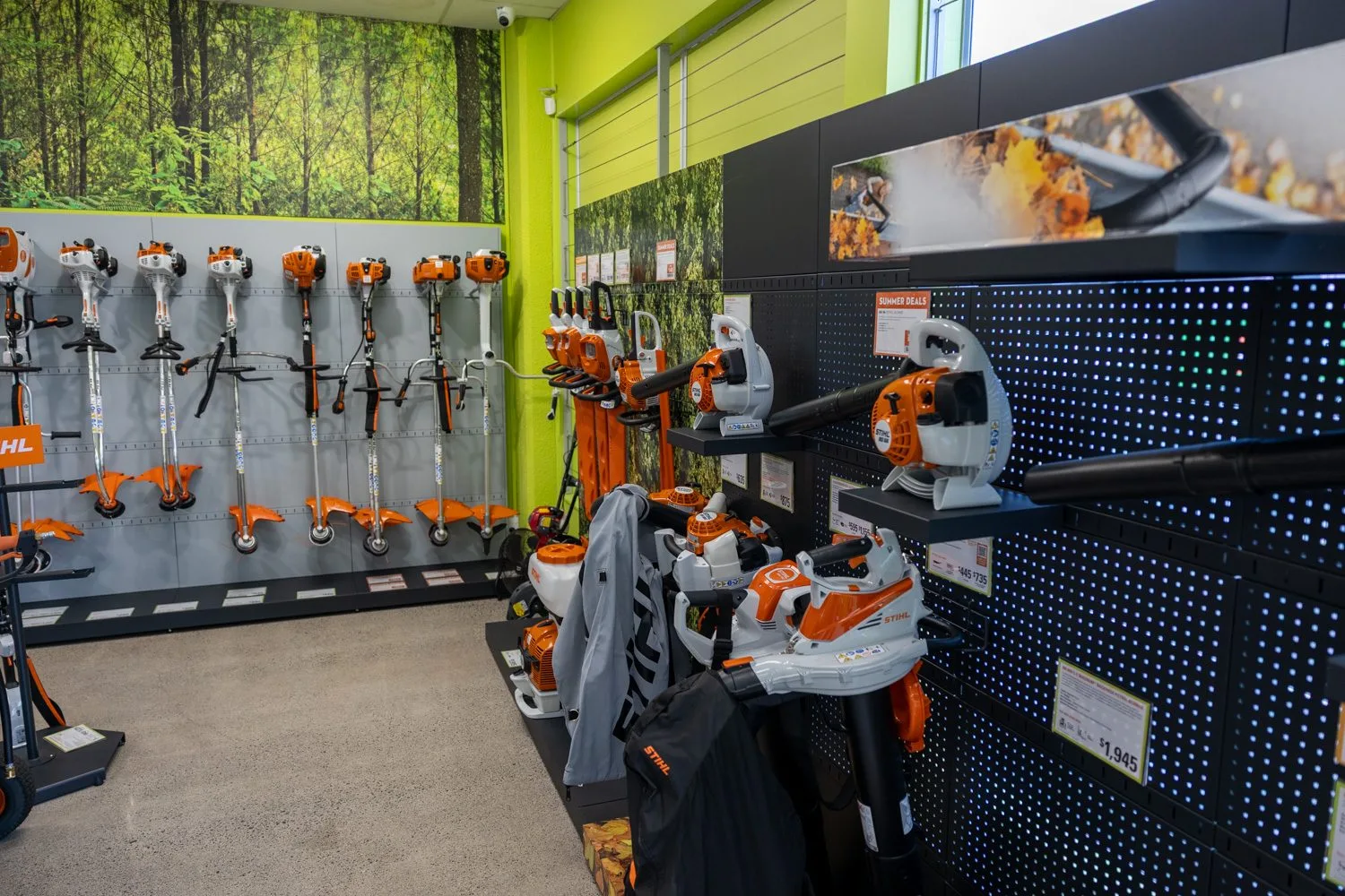STIHL brushcutters and harnesses displayed on the showroom wall